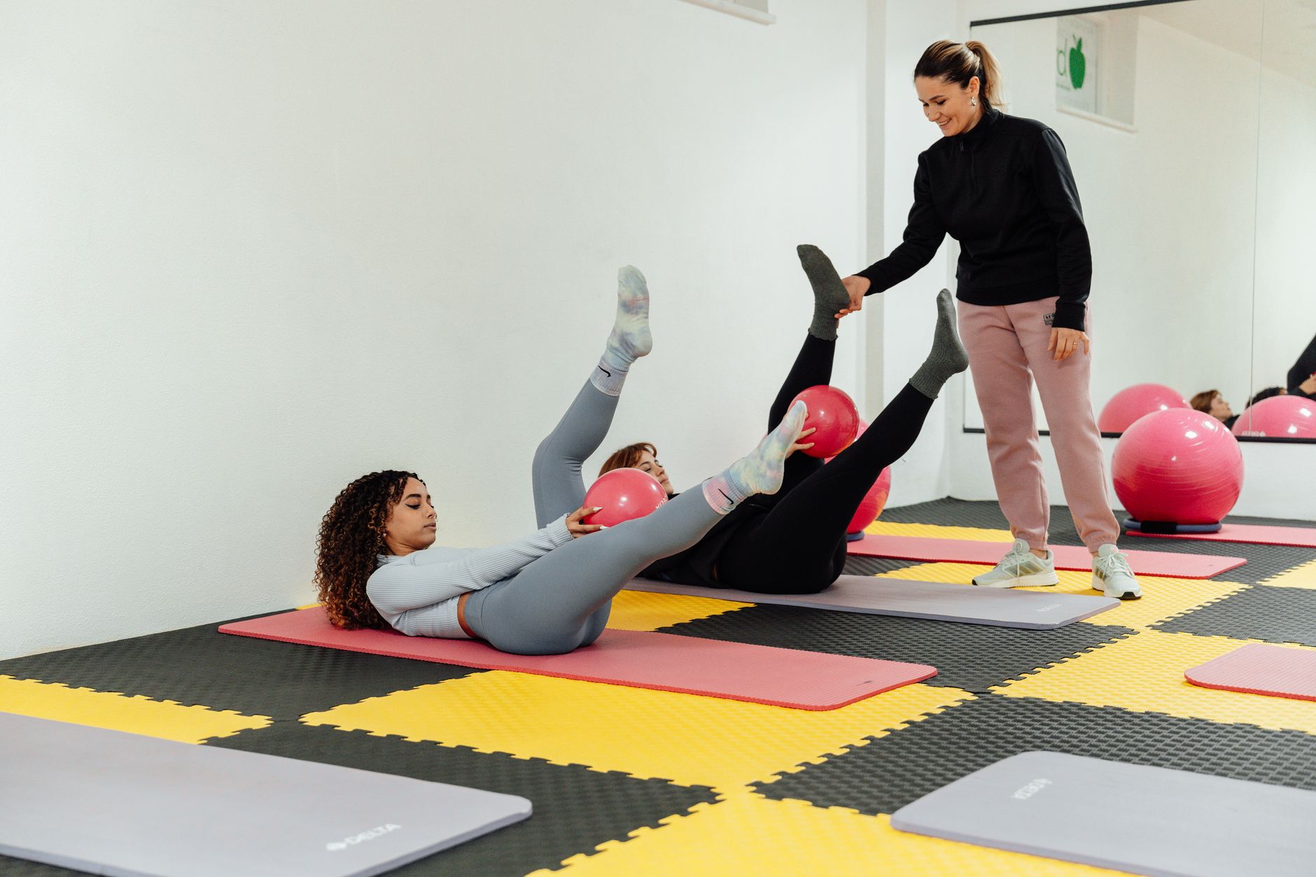 a focused person doing mat pilates exercises on a floor mat