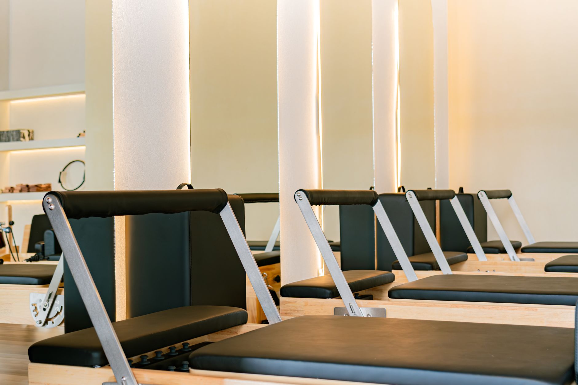 modern pilates studio interior with reformers and sunlight