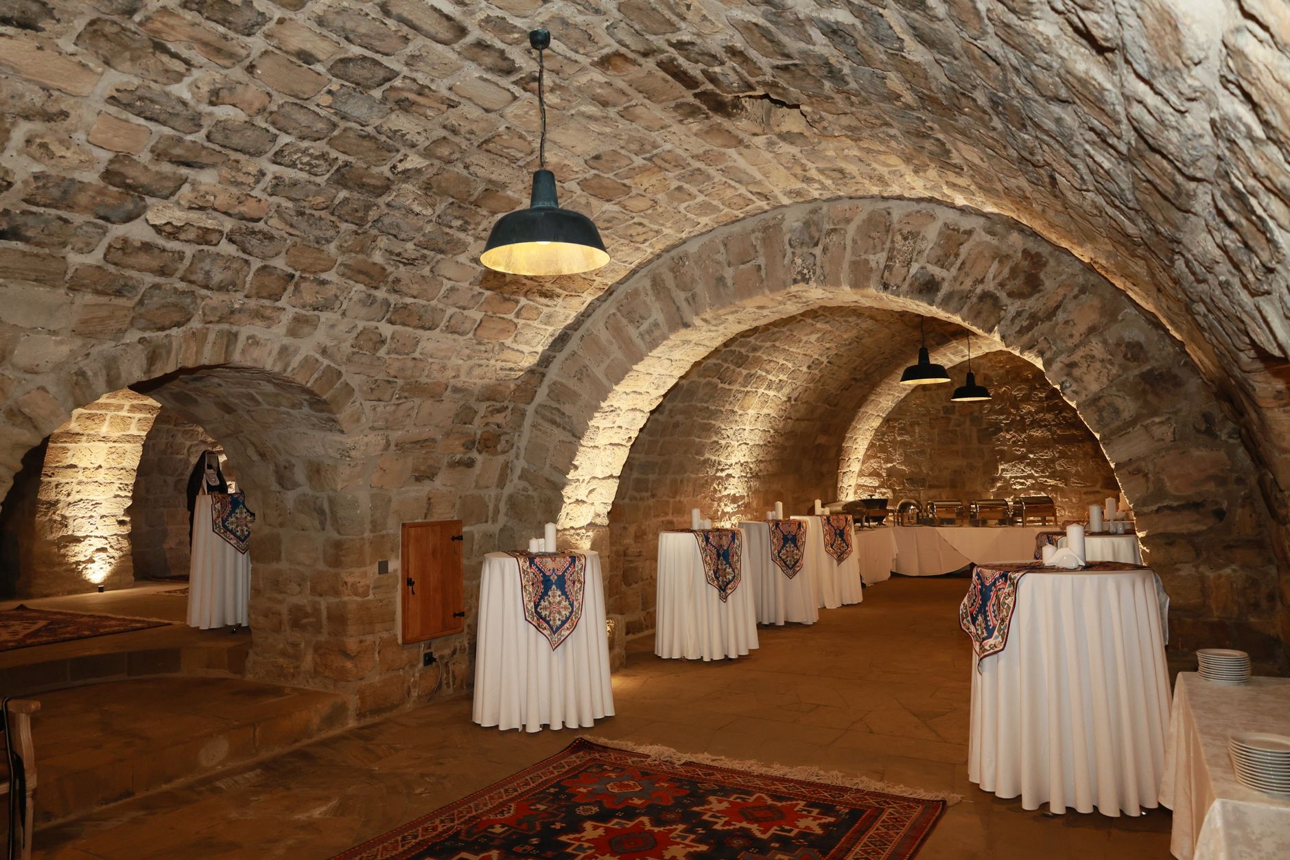 A cozy elegantly decorated small event venue with warm lighting and comfortable