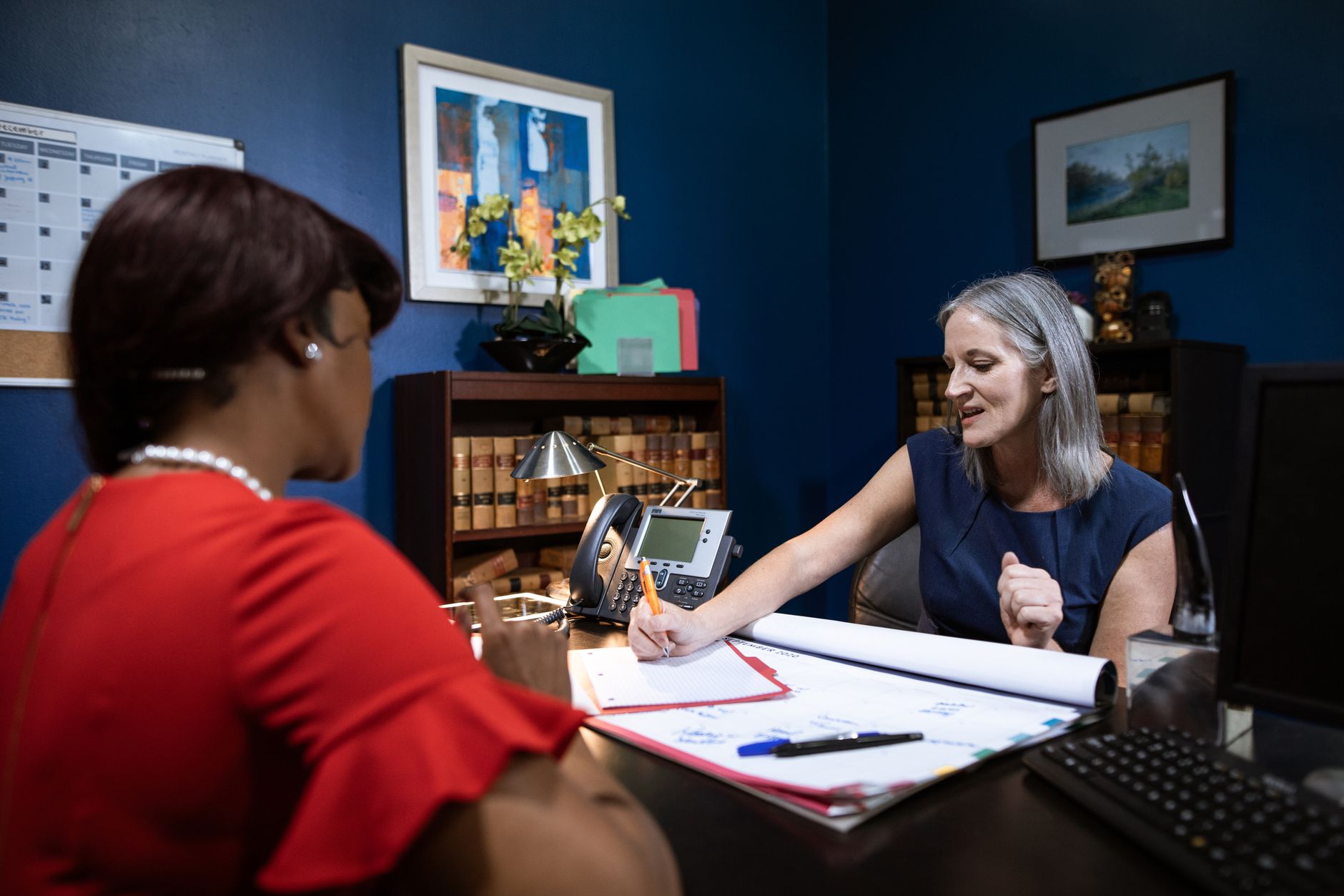 event planners discussing details with a client in an office