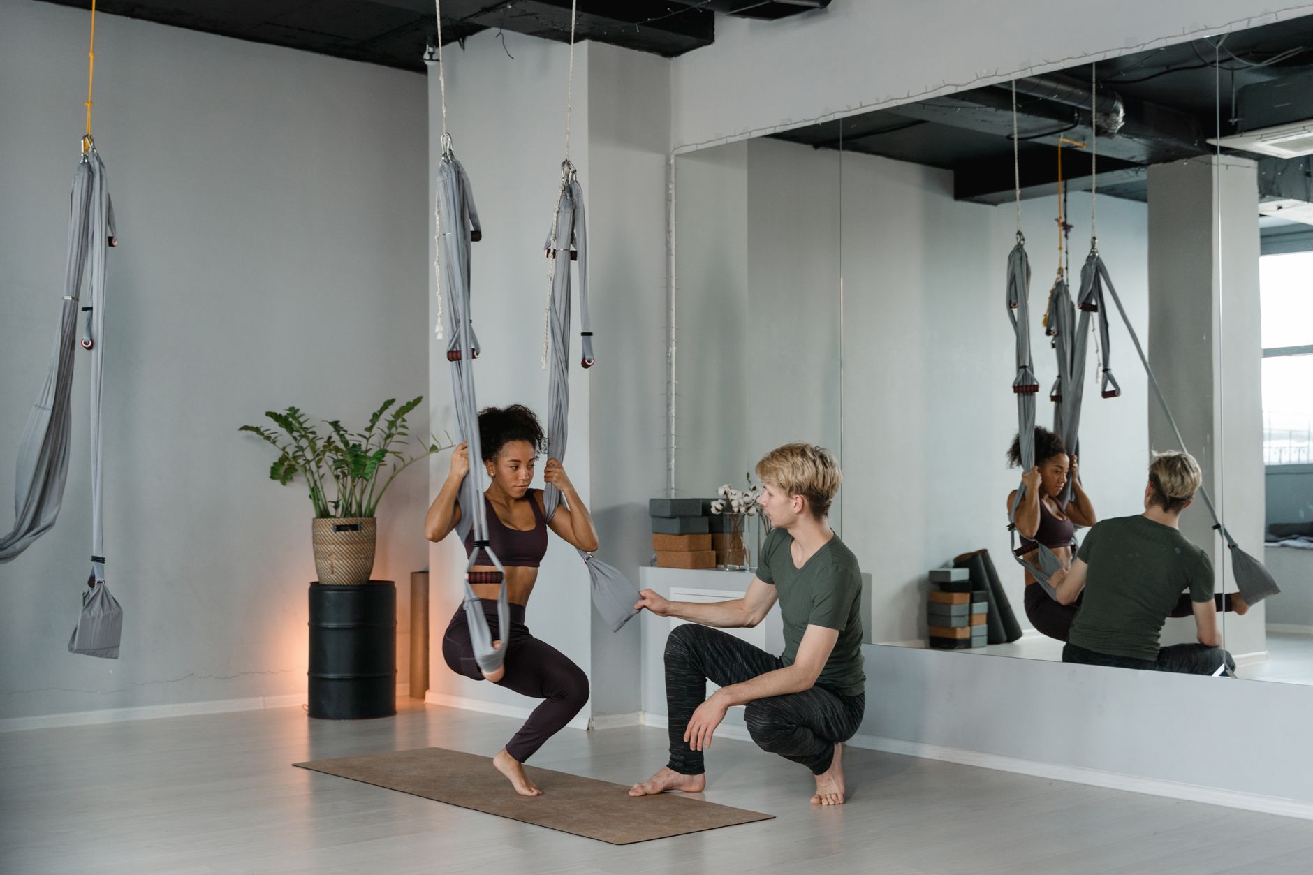 instructor guiding a student during private fitness session in studio