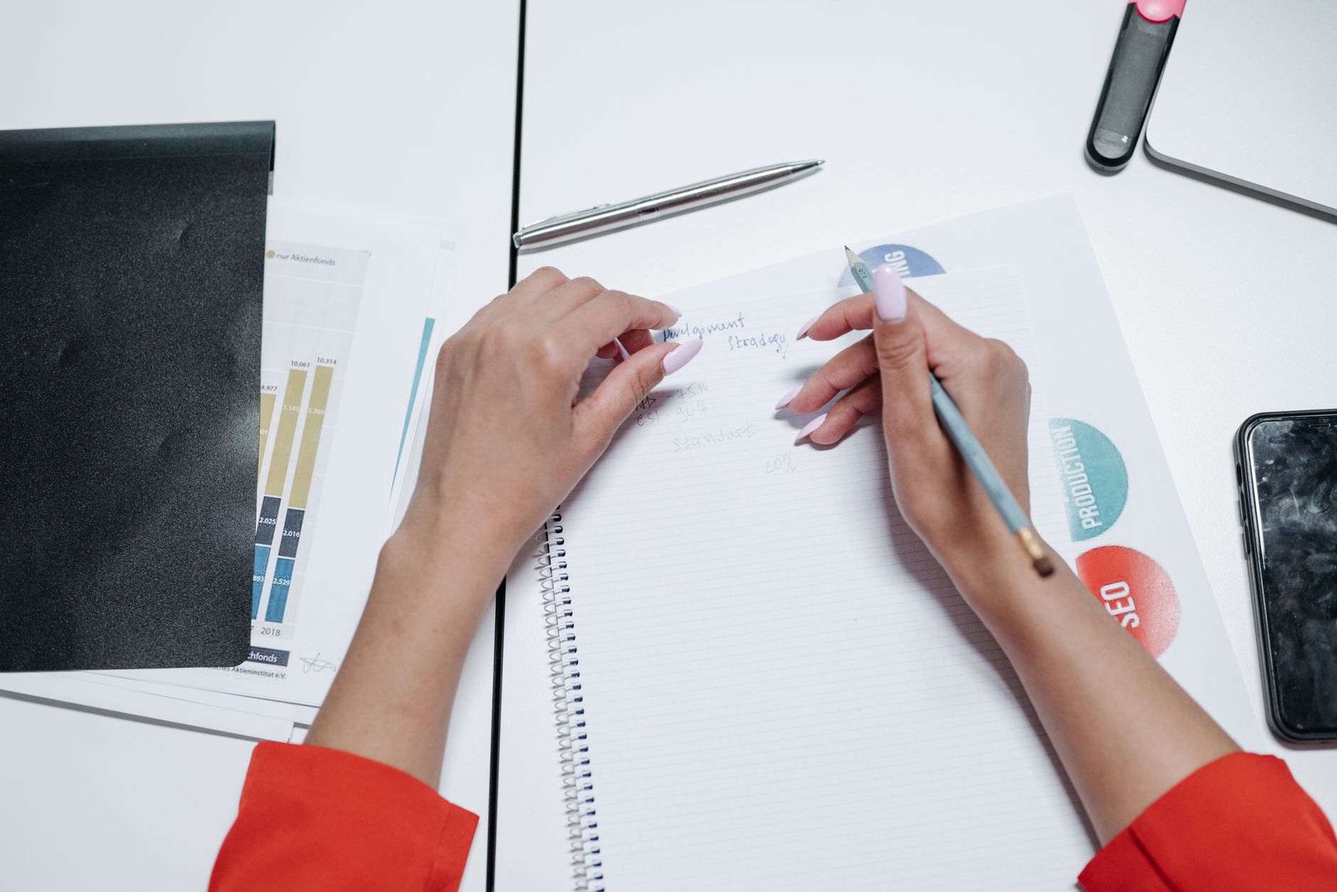organized event planner taking notes in a clean workspace